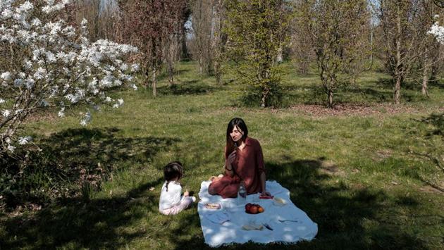 Chiara Zuddas has a picnic with her daughter Bianca Toniolo by a blossom tree in the woods 200 metres from their home in San Fiorano. Toniolo, his wife and daughter look forward to moving into their new home when possible, knowing that, if needed, they are just metres away from the older generation. It will continue to be a family affair. (Marzio Toniolo via REUTERS) Chiara Zuddas has a picnic with her daughter Bianca Toniolo by a blossom tree in the woods 200 metres from their home in San Fiorano. Toniolo, his wife and daughter look forward to moving into their new home when possible, knowing that, if needed, they are just metres away from the older generation. It will continue to be a family affair. (Marzio Toniolo via REUTERS)