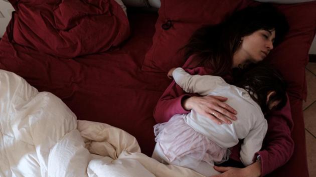 Chiara Zuddas sleeps in bed cuddling her daughter Bianca. They moved from Milan, found jobs in local schools, and were waiting for their house in the town to be ready for moving in. Toniolo’s father, Massimo, 62, was visiting from Sardinia. (Marzio Toniolo via REUTERS) Chiara Zuddas sleeps in bed cuddling her daughter Bianca. They moved from Milan, found jobs in local schools, and were waiting for their house in the town to be ready for moving in. Toniolo’s father, Massimo, 62, was visiting from Sardinia. (Marzio Toniolo via REUTERS)