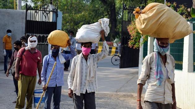 Migrant labourers stand in a queue for thermal screening as they arrive from Madhya Pradesh via Buses during the nationwide Covid-19 lockdown in Prayagraj on Thursday. (ANI) Migrant labourers stand in a queue for thermal screening as they arrive from Madhya Pradesh via Buses during the nationwide Covid-19 lockdown in Prayagraj on Thursday. (ANI)