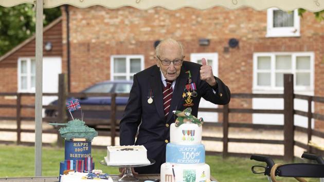 Second World War veteran Captain Tom Moore poses with birthday cakes as he celebrates his 100th birthday, in Bedford, England on Thursday, April 30. A British army veteran who started walking laps in his garden as part of a fundraiser for the National Health Service, Moore was also promoted to Honorary Colonel of the Army Foundation College in Harrogate. (Emma Sohl / Capture the Light Photography via AP) Second World War veteran Captain Tom Moore poses with birthday cakes as he celebrates his 100th birthday, in Bedford, England on Thursday, April 30. A British army veteran who started walking laps in his garden as part of a fundraiser for the National Health Service, Moore was also promoted to Honorary Colonel of the Army Foundation College in Harrogate. (Emma Sohl / Capture the Light Photography via AP)