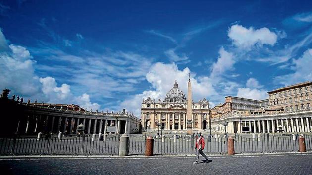 A woman walks at the Saint Peter’s Square in Rome, Italy. A woman walks at the Saint Peter’s Square in Rome, Italy.