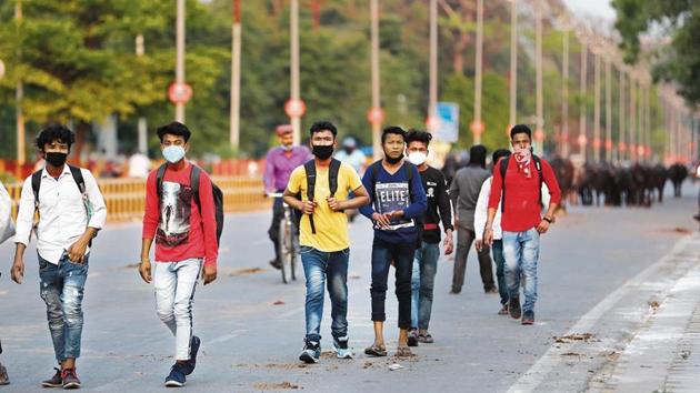 Workers arrive to catch a bus to travel to their home states, in Uttar Pradesh’s Prayagraj. Workers arrive to catch a bus to travel to their home states, in Uttar Pradesh’s Prayagraj.