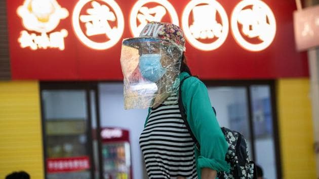 A passenger wearing a face shield is seen at a long-distance bus station in Wuhan in China's central Hubei province on April 30, 2020, ahead of the Labor Day holiday which starts on May 1. (AFP photo) A passenger wearing a face shield is seen at a long-distance bus station in Wuhan in China's central Hubei province on April 30, 2020, ahead of the Labor Day holiday which starts on May 1. (AFP photo)