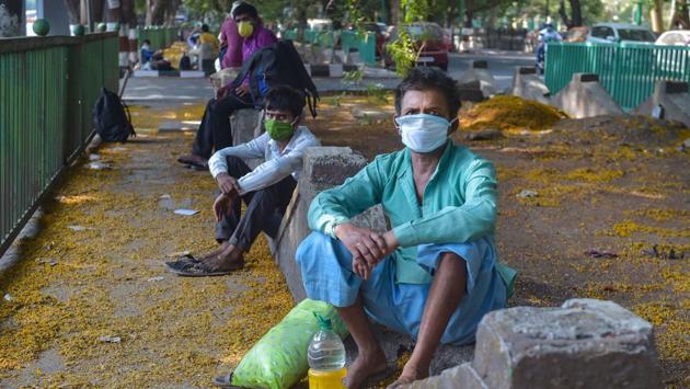 Migrant workers from Lucknow rest along the Eastern Express Highway on their way to the native towns and villages, in Thane on April 29. A three-judge bench headed by justice NV Ramana passed the order in a plea by a petitioner who highlighted the plight of migrant labourers because they did not have local identity proof. (Mitesh Bhuvad / PTI) Migrant workers from Lucknow rest along the Eastern Express Highway on their way to the native towns and villages, in Thane on April 29. A three-judge bench headed by justice NV Ramana passed the order in a plea by a petitioner who highlighted the plight of migrant labourers because they did not have local identity proof. (Mitesh Bhuvad / PTI)