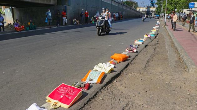 People’s belongings kept as placeholders in a queue for ration in Pune, on April 27. Activist Nikhil Dey told HT that there are many limitations to extending the “one nation, one ration card” even temporarily. “Different schemes and coverage exists in different states, so they are reluctant to recognise migrants as being entitled to their schemes.” (PTI) People’s belongings kept as placeholders in a queue for ration in Pune, on April 27. Activist Nikhil Dey told HT that there are many limitations to extending the “one nation, one ration card” even temporarily. “Different schemes and coverage exists in different states, so they are reluctant to recognise migrants as being entitled to their schemes.” (PTI)