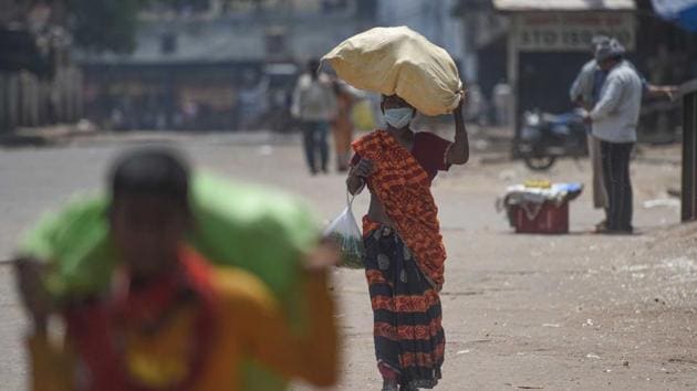People carrying bundles of vegetables during lockdown, in at Azadpur Mandi, New Delhi, India, on Friday, May 1, 2020. (Sanchit Khanna/HT PHOTO) People carrying bundles of vegetables during lockdown, in at Azadpur Mandi, New Delhi, India, on Friday, May 1, 2020. (Sanchit Khanna/HT PHOTO)