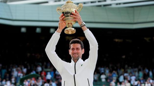 FILE PHOTO: Tennis - Wimbledon - All England Lawn Tennis and Croquet Club, London, Britain - July 14, 2019 Serbia's Novak Djokovic with the trophy as he celebrates winning the final against Switzerland's Roger Federer REUTERS/Andrew Couldridge/File Photo (REUTERS) FILE PHOTO: Tennis - Wimbledon - All England Lawn Tennis and Croquet Club, London, Britain - July 14, 2019 Serbia's Novak Djokovic with the trophy as he celebrates winning the final against Switzerland's Roger Federer REUTERS/Andrew Couldridge/File Photo (REUTERS)