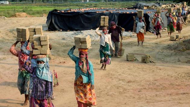 Labourers work at a brick factory on the eve of Labour Day during the countrywide lockdown due to coronavirus pandemic, in Balurghat on Thursday. (ANI File Photo) Labourers work at a brick factory on the eve of Labour Day during the countrywide lockdown due to coronavirus pandemic, in Balurghat on Thursday. (ANI File Photo)