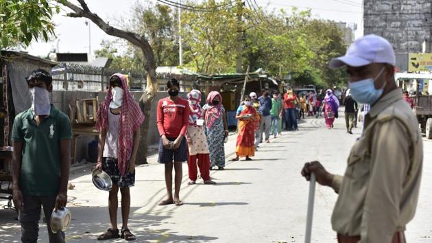 Homeless people stand in a queue at a food distribution by Noida Authority at Morna Village in Sector 35, on day eighteen of the 21 day lockdown to limit the coronavirus, in Noida, India, on Saturday, April 11, 2020. (Virendra Singh Gosain/HT PHOTO) Homeless people stand in a queue at a food distribution by Noida Authority at Morna Village in Sector 35, on day eighteen of the 21 day lockdown to limit the coronavirus, in Noida, India, on Saturday, April 11, 2020. (Virendra Singh Gosain/HT PHOTO)