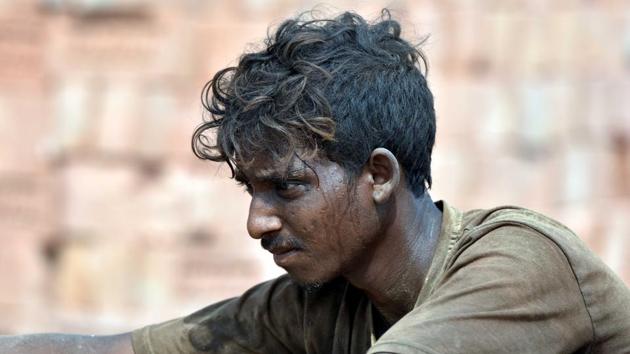 With the entire country in a lockdown against the spread of the coronavirus, thousands of migrant workers have not been able to make it back home to their villages. India’s large workforce of migrant labour, such as this man working in the brick kiln, has little access to any protective gear against the pandemic. (Parwaz Khan / HT Photo)