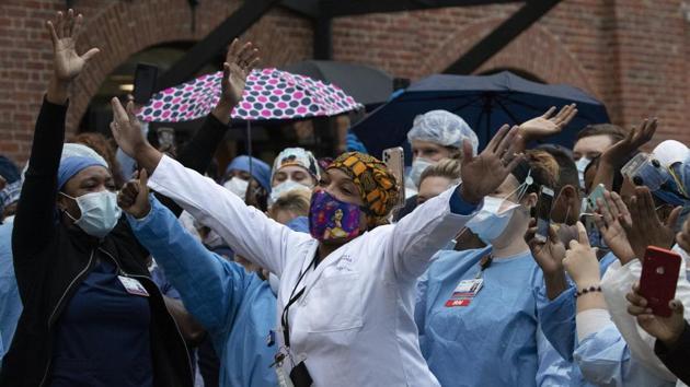 Healthcare workers react to the applause at Brooklyn's Kings County Hospital Center during a 7 o'clock ceremony during the coronavirus pandemic, Friday, April 24, 2020, in New York.(AP) Healthcare workers react to the applause at Brooklyn's Kings County Hospital Center during a 7 o'clock ceremony during the coronavirus pandemic, Friday, April 24, 2020, in New York.(AP)