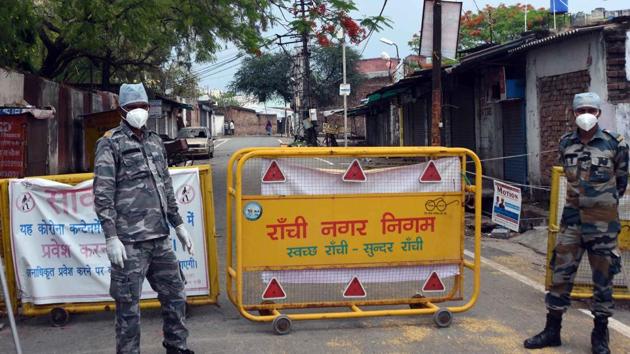 Security personnel stand guard at Hindpirhi locality, one of the coronavirus containment zone, during lockdown in Ranchi on Wednesday. (Diwakar Prasad/HT Photo) Security personnel stand guard at Hindpirhi locality, one of the coronavirus containment zone, during lockdown in Ranchi on Wednesday. (Diwakar Prasad/HT Photo)