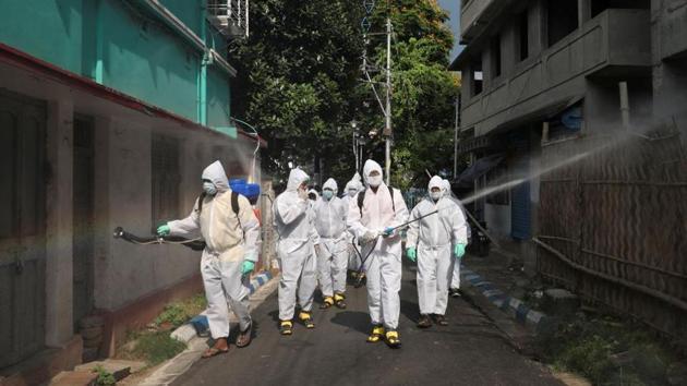 Municipal workers wearing protective gear spray disinfectant in a residential area during a nationwide lockdown to slow the spreading of the coronavirus disease (COVID-19) (Representative)