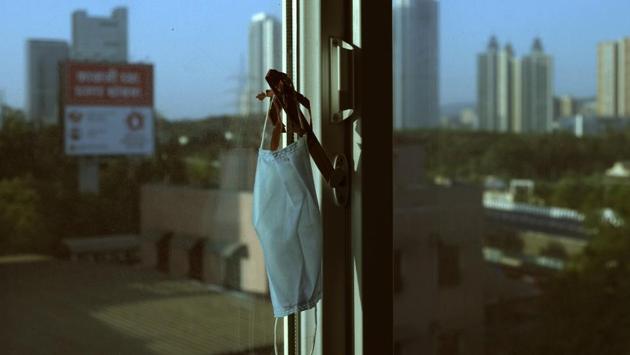 Rafiq Maqbool's mask hangs on a good luck charm made by his daughter, in the hotel room he was quarantined in Mumbai, on April 23, 2020. “Keep it with you, daddy. We made you a good luck charm. It has special powers,” Maqbool's younger daughter said after he tested positive for COVID-19 and was leaving home. (Rafiq Maqbool / AP) Rafiq Maqbool's mask hangs on a good luck charm made by his daughter, in the hotel room he was quarantined in Mumbai, on April 23, 2020. “Keep it with you, daddy. We made you a good luck charm. It has special powers,” Maqbool's younger daughter said after he tested positive for COVID-19 and was leaving home. (Rafiq Maqbool / AP)