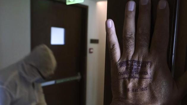 A stamp for a 14-day home quarantine is seen on the hand of Associated Press photographer Rafiq Maqbool. On day 5, Maqbool and the other hotel residents were tested again. When the results come back two days later, he and his colleagues were found to be negative for the virus. Later that day, on April 27, he was reunited with his family. (Rafiq Maqbool / AP) A stamp for a 14-day home quarantine is seen on the hand of Associated Press photographer Rafiq Maqbool. On day 5, Maqbool and the other hotel residents were tested again. When the results come back two days later, he and his colleagues were found to be negative for the virus. Later that day, on April 27, he was reunited with his family. (Rafiq Maqbool / AP)