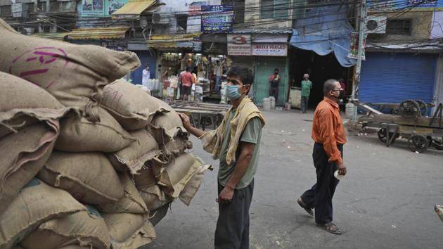 A daily wage migrant labourer looks at sacks to be carried to a shop at a largely closed wholesale market in the old quarters of Delhi during a nation wide lockdown to control the spread of coronavirus, in New Delhi, India, Thursday, April 30, 2020. (AP photo)