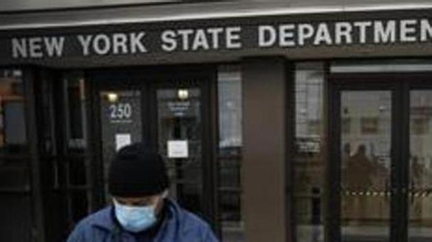Visitors to the Department of Labor are turned away at the door by personnel due to closures over coronavirus concerns, Wednesday, March 18, 2020, in New York. Applications for jobless benefits are surging in some states as coronavirus concerns shake the U.S. economy. (AP) Visitors to the Department of Labor are turned away at the door by personnel due to closures over coronavirus concerns, Wednesday, March 18, 2020, in New York. Applications for jobless benefits are surging in some states as coronavirus concerns shake the U.S. economy. (AP)