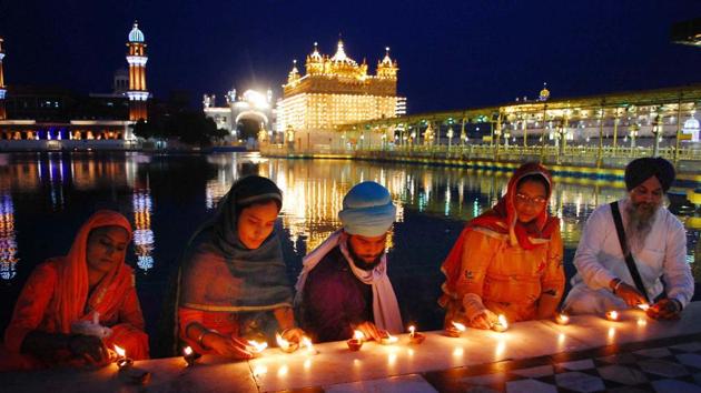 Devotees light oil lamps on the birth anniversary of Guru Angad Dev, at Golden Temple, in Amritsar, Punjab. (Sameer Sehgal / Hindustan Times) Devotees light oil lamps on the birth anniversary of Guru Angad Dev, at Golden Temple, in Amritsar, Punjab. (Sameer Sehgal / Hindustan Times)
