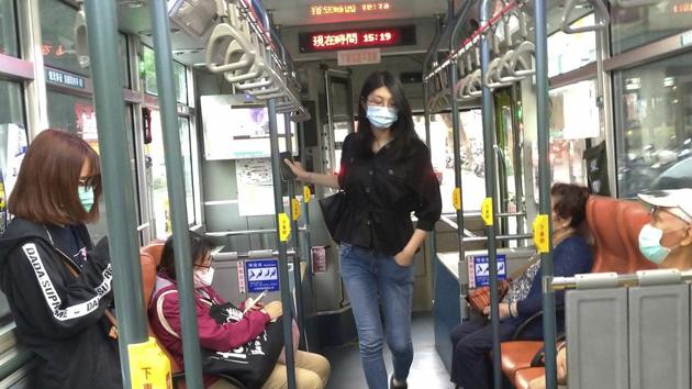 People wear face masks to protect against the spread of the new coronavirus as they ride on a bus in Taipei, Taiwan. (AP)