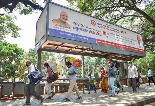 Migrant workers arrive at the District Collector's office after the government allowed conditional travel in Bengaluru on May 1. Amid apprehensions that the announcement of special trains could lead to crowding in stations, the railway ministry has reiterated that special trains were planned for nominated people identified and registered by state governments. (Shailendra Bhojak / PTI)