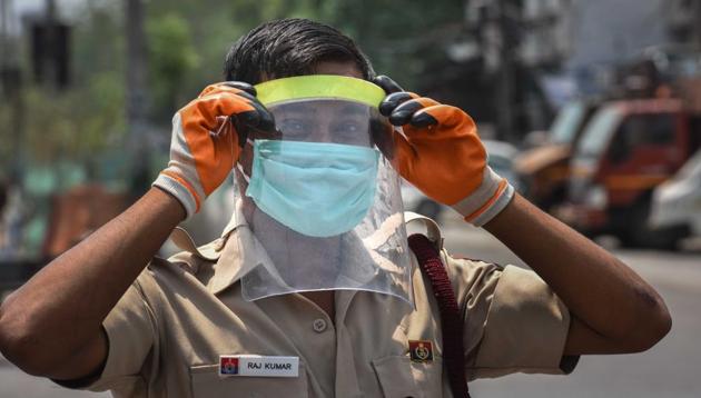 Civil defence personnel wearing a face shield in a coronavirus Covid-19 hotspot area in Jahangirpuri, New Delhi. (Sanchit Khanna/HT PHOTO) Civil defence personnel wearing a face shield in a coronavirus Covid-19 hotspot area in Jahangirpuri, New Delhi. (Sanchit Khanna/HT PHOTO)
