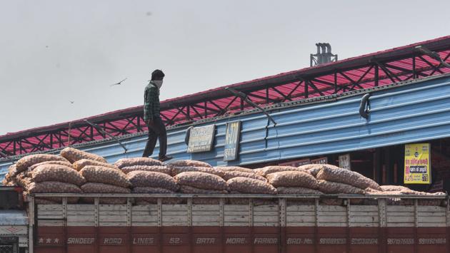 A worker seen on top of a truck in Azadpur Mandi. According to the data shared by the agriculture produce market committee (APMC), the three major markets in Delhi — Azadpur, Ghazipur and Okhla — have recorded a 25-40% drop in fresh stocks of fruits and vegetables, including bottle gourd, ridged gourd, brinjal, okra, coriander leaves, cucumber, musk melon and water melon, at a point that is considered the start of the season, reported HT on May 1. (Sanchit Khanna/HT PHOTO)