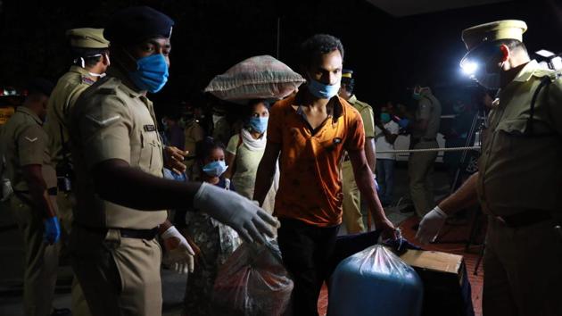 Migrant workers arrive at Aluva railway station to board on a special train to Odisha from Kochi on May 1. The Centre had come up with a protocol for road movement on Wednesday, after persistent demands by states. The Ministry of Home Affairs included trains as a means of transporting people on Thursday, after an assessment of the scale of movement. (Arun Chandrabose / AFP)