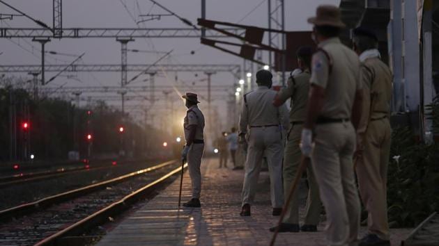 Railway Protection Force personnel stand at a platform as a special train carrying migrant workers from Nashik arrives early morning at Misrod railway station in Bhopal on May 02. (Gagan Nayar / AFP)