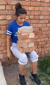 Judoka player Priya using bricks to workout at home in Ludhiana. (HT Photo) Judoka player Priya using bricks to workout at home in Ludhiana. (HT Photo)