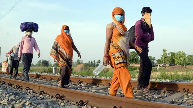 A group of migrant workers make their way to Lucknow from Jammu, where they began on April 26 during the lockdown, in Jalandhar on May 1. (ANI)