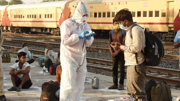 Thermal screening of migrant workers being conducted after they arrive from Nashik by a special train at Misrod railway station in Bhopal, Saturday, May 02. (PTI)