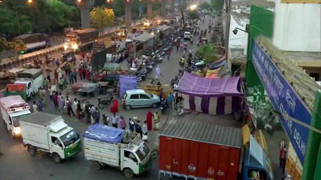 People and vehicles queue to enter Azadpur Mandi in the morning. The market received 5,000 tonnes of fruits and vegetables on Wednesday, a fall from the 7,500 tonnes, which is the average during the lockdown. Supply improved slightly on Thursday to 6,000 tonnes, as the movement of essential vehicles was allowed across borders, Adil Khan told HT. (ANI)