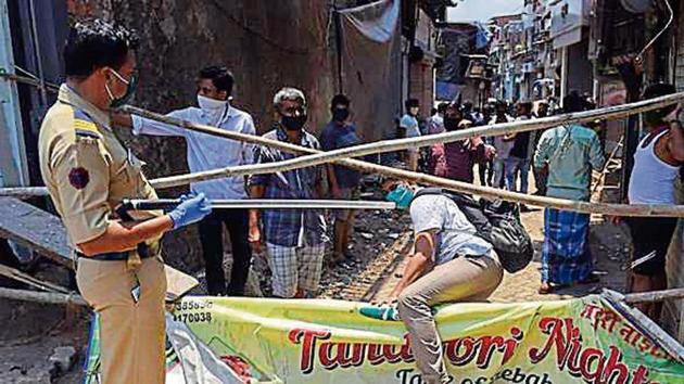 Migrants line up to fill forms at Dharavi on Saturday.