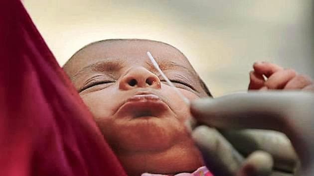 A medical worker collects a swab sample from an infant to test for Covid-19 in Nabi Karim on Saturday.