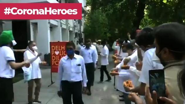 The image shows doctors showering petals on police personnel.(Twitter/ANI)