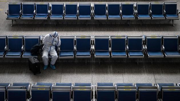 A passenger wears a hazmat suit as a precaution against the Covid-19 coronavirus as he waits for a train at Hankou Railway Station in Wuhan, in China's central Hubei province on May 2, 2020, the second day of a five-day national holiday. (AFP photo) A passenger wears a hazmat suit as a precaution against the Covid-19 coronavirus as he waits for a train at Hankou Railway Station in Wuhan, in China's central Hubei province on May 2, 2020, the second day of a five-day national holiday. (AFP photo)