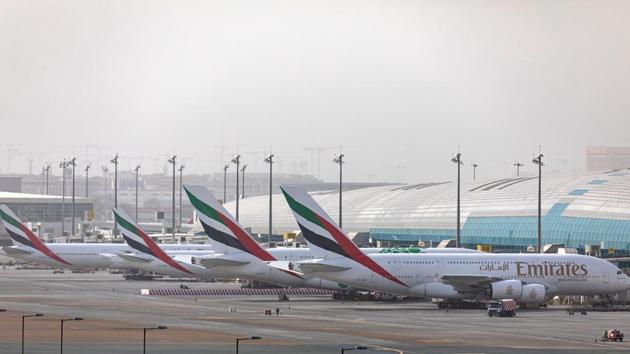 An Airbus SE A380-800 aircraft, right, stands alongside a line of Boeing Co. 777-300 aircraft, operated by Emirates, at Dubai International Airport in Dubai, United Arab Emirates. (Bloomberg) An Airbus SE A380-800 aircraft, right, stands alongside a line of Boeing Co. 777-300 aircraft, operated by Emirates, at Dubai International Airport in Dubai, United Arab Emirates. (Bloomberg)