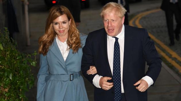 (FILES) In this file photo taken on September 28, 2019 Britain's Prime Minister Boris Johnson (R) walks with his partner Carrie Symonds . (AFP) (FILES) In this file photo taken on September 28, 2019 Britain's Prime Minister Boris Johnson (R) walks with his partner Carrie Symonds . (AFP)