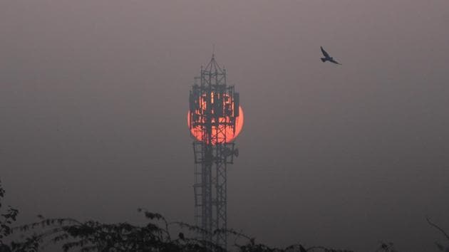 The sun rises behind a mobile communications tower on a winter cold morning, in Gurugram. (Yogendra Kumar/HT PHOTO) The sun rises behind a mobile communications tower on a winter cold morning, in Gurugram. (Yogendra Kumar/HT PHOTO)
