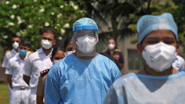 The staff of INHS Asvini hospital wearing protective gear stand before they were showered with flower petals by Indian Navy's Chetak helicopter as part of an event to show gratitude towards the frontline warriors fighting the coronavirus disease (COVID-19) outbreak, in Mumbai, India, May 3, 2020. (REUTERS) The staff of INHS Asvini hospital wearing protective gear stand before they were showered with flower petals by Indian Navy's Chetak helicopter as part of an event to show gratitude towards the frontline warriors fighting the coronavirus disease (COVID-19) outbreak, in Mumbai, India, May 3, 2020. (REUTERS)