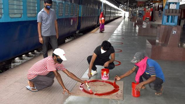 Railway employees making social distancing marks (ANI) Railway employees making social distancing marks (ANI)