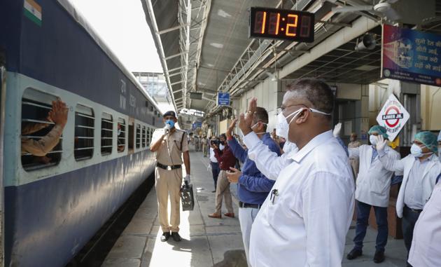 Officials in Ajmer see off stranded pilgrims who boarded a special train for their home in West Bengal.(Deepak Sharma/HT PHOTO)