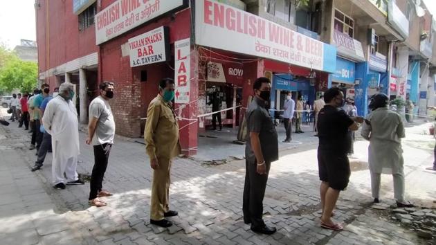 People queue outside a liquor shop during the extended nationwide lockdown, in Chandigarh. The Union Territory (UT) which is designated as red zone – only standalone liquor shops are allowed to open till 7 pm. (Keshav Singh / HT Photo)