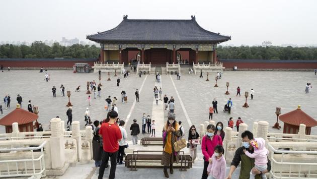 Visitors wearing protective masks walk through the Temple of Heaven complex in Beijing. China has reported 82,877 cases with 4,633 deaths until now. On April 8, Wuhan – believed to be the epicentre of novel coronavirus, lifted its restrictions after 70 days of strict lockdown, reported HT. (Giulia Marchi / Bloomberg) Visitors wearing protective masks walk through the Temple of Heaven complex in Beijing. China has reported 82,877 cases with 4,633 deaths until now. On April 8, Wuhan – believed to be the epicentre of novel coronavirus, lifted its restrictions after 70 days of strict lockdown, reported HT. (Giulia Marchi / Bloomberg)