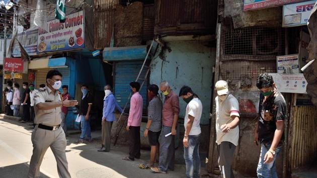 Stranded migrant workers stand outside doctors’ dispensary for medical report before registering for special transportations organised to take them back to their hometowns during the Covid-19 lockdown, in Mumbai on Sunday.(Satish Bate/HT Photo) Stranded migrant workers stand outside doctors’ dispensary for medical report before registering for special transportations organised to take them back to their hometowns during the Covid-19 lockdown, in Mumbai on Sunday.(Satish Bate/HT Photo)