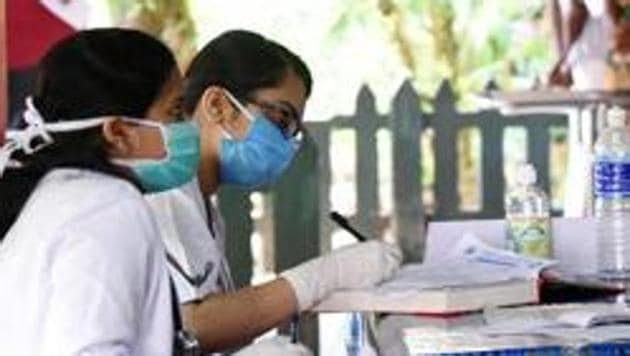 Doctors consulting patients in special fever desk at Ernakulam General hospital during the nationwide lockdown, in wake of coronavirus pandemic, in Kochi on Wednesday. (ANI Photo)(ANI)