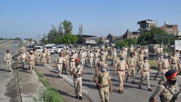 Police holding a flag march in Ludhiana on Monday. (Gurpreet Singh/HT)