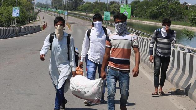 Migrant workers walking back on their way back to their states, Ludhiana, Punjab, Sunday, May 3, 2020. (HT File Photo) Migrant workers walking back on their way back to their states, Ludhiana, Punjab, Sunday, May 3, 2020. (HT File Photo)