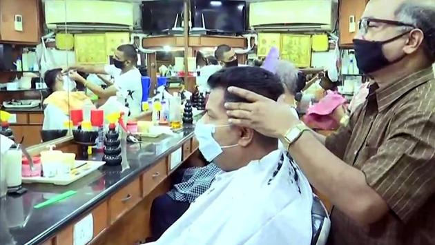 Barbers seen at work inside a salon during the extended lockdown in Panaji, Goa. Goa is also designated as a green zone. (ANI)