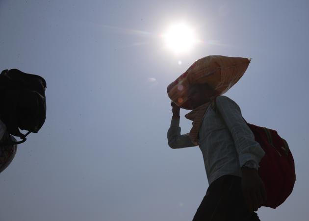 Migrant workers trying to return to their villages hundreds of miles away walk through a highway during a nationwide lockdown to curb the spread of new coronavirus in India. (AP photo) Migrant workers trying to return to their villages hundreds of miles away walk through a highway during a nationwide lockdown to curb the spread of new coronavirus in India. (AP photo)